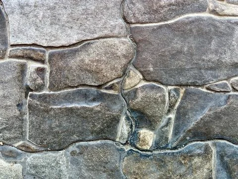 Rustic Natural Stone Wall with Varying Shapes Stock Photos