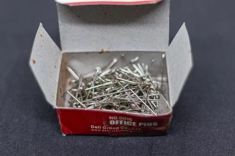 Rustic Office Pins Box with Silver Nails on Dark Fabric Background Stock Photos