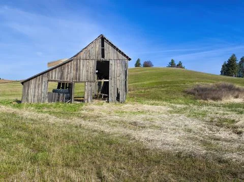 Rustic old barn in field. Stock Photos