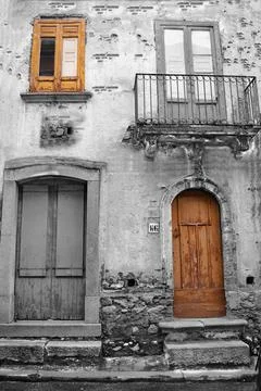Rustic old building facade with weathered doors and windows 库存照片