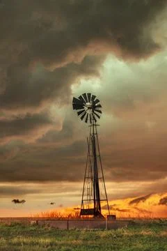 Rustic old farming windmill in stormy weather Stock-Fotos