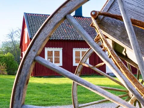 Rustic old red house framed by the wheel Stock Photos