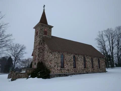 Rustic Old Stone Church in Winter Snow Stock Photos