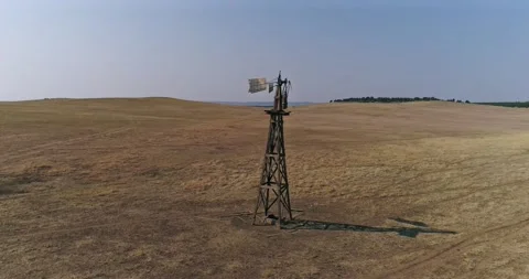 Rustic old windmill in a pasture of bison on the Great American Plains Stock Footage 167361707