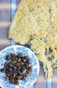 Rustic olive flatbread and plate with olives Stock Photos