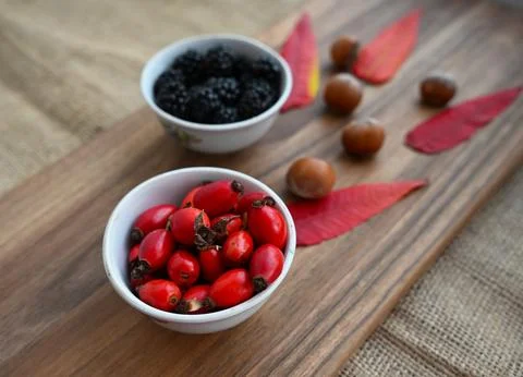 Rustic Organic Berry Selection with Fresh Sea Buckthorn and Blackberries Fotos de archivo