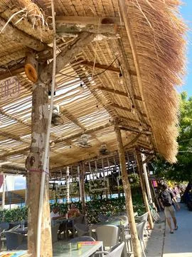 Rustic Outdoor Café Under Bamboo Canopy with Relaxed Summer Atmosphere Stock Photos