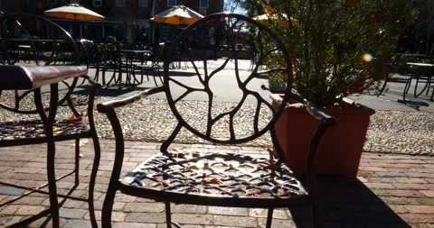 Rustic outdoor chair with fall leaves in a cozy café setting Stock Footage 281704796