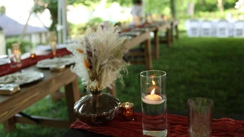 Rustic outdoor dinner table with candles and flowers Stock Footage 337723314