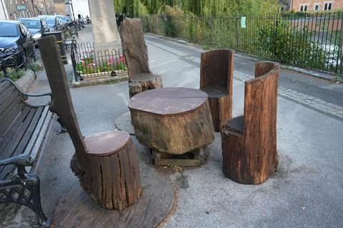 Rustic Outdoor Seating, Tree Stump Furniture On Paved Path, Cromford, England. Stock Photos