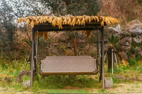 Rustic Outdoor Swing Covered With Dried Leaves Stock Photos