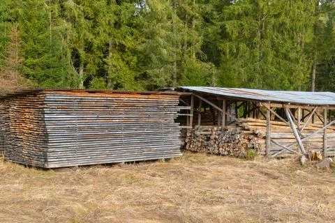 A rustic outdoor wood storage setup, used for drying or seasoning lumber. Stock Photos