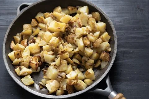 Rustic pan fried potatoes Stock Photos