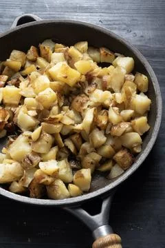 Rustic pan fried potatoes Stock Photos