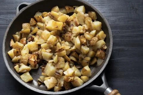 Rustic pan fried potatoes Stock Photos