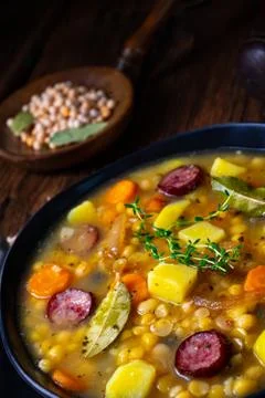 Rustic pea soup with bacon and sausages Stock Photos