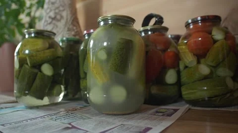 Rustic pickles, cucumbers and tomatoes on the shelf in jars Stock Footage 261451893