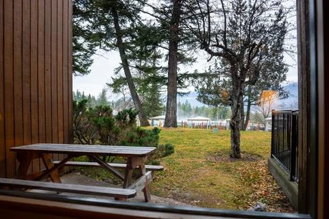 A rustic picnic table with a beautiful view of nature from a window frame. Stock Photos