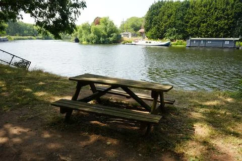 Rustic Picnic Table By Tranquil River In Farndon, Nottinghamshire, England With Stock Photos