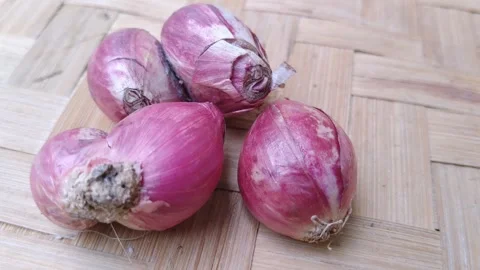 Rustic pile of small red onions on a traditional bamboo background Stock Footage 344089083