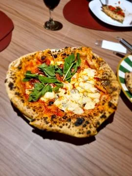 Rustic Pizza with Arugula Topping Stock Photos