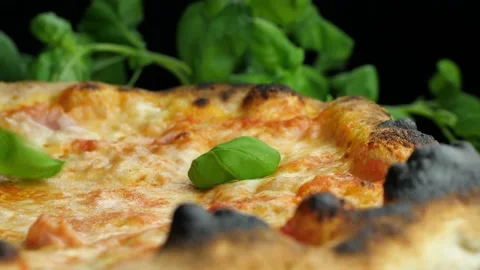 Rustic pizza crust with basil closeup Stock-Footage 168387286