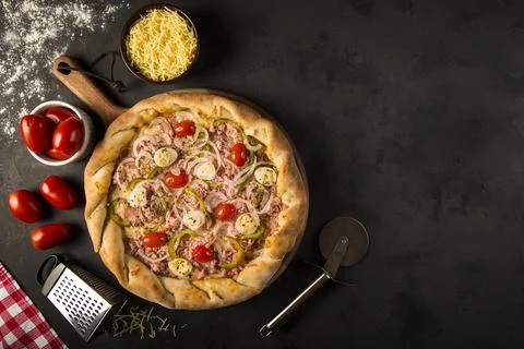 Rustic pizza on dark background Stock Photos