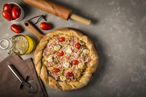 Rustic pizza on dark background Stock Photos