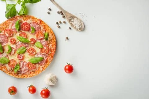 Rustic pizza with salami, mozzarella, cherry and a view of the basilica with  Stock Photos