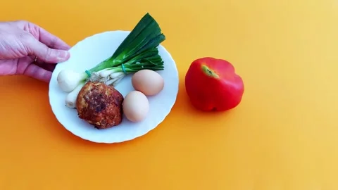 Rustic Plate Offering: Eggs, Meatball Greens in Orange Warmth Video stock 312808557