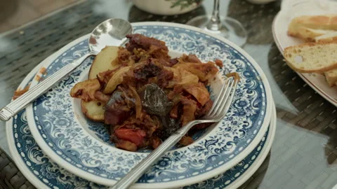 Rustic plated vegetable medley with potatoes, peppers, onions and bread on Stock Footage 345270619