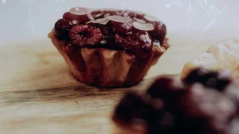 Rustic plating process view: revealing glossy fruit over pastry cream Stock Photos