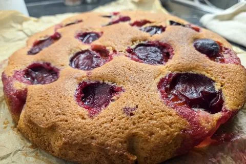Rustic Plum Cake on Parchment Paper for Baking Enthusiasts and Dessert Lovers Photos