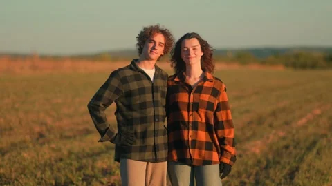 Rustic portrait of young farmers looking at camera in plaid shirts standing Stock Footage 317084051