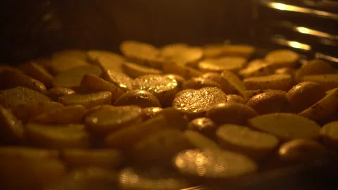 Rustic potatoes are baked in an oven. Potatoes with spices are fried in oil Stock Footage 173357112