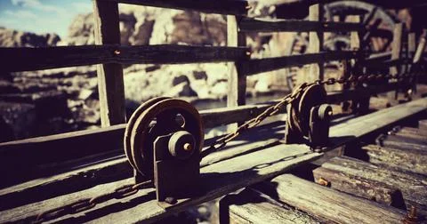 Rustic pulley system on a wooden bridge in a natural landscape 库存插图