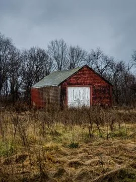 Rustic Red Barn in an Overgrown Field Stock Photos