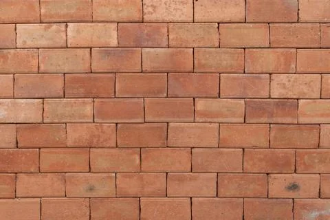 A rustic red brick wall with a weathered texture, showcasing earthy tones a.. Stock Photos