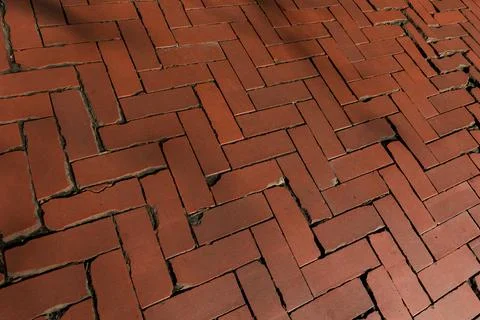Rustic red clay brick walkway texture, old herringbone pattern street pavement Stock Photos