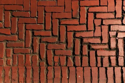 Rustic red clay brick walkway texture, old herringbone pattern street pavement Stock Photos