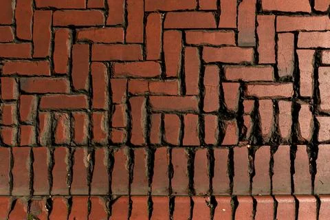 Rustic red clay brick walkway texture, old herringbone pattern street pavement Stock Photos