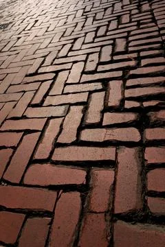 Rustic red clay brick walkway texture, old herringbone pattern street pavement Stock Photos