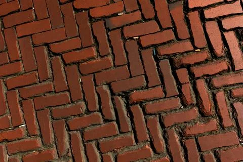 Rustic red clay brick walkway texture, old herringbone pattern street pavement Stock Photos