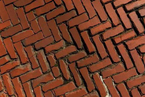 Rustic red clay brick walkway texture, old herringbone pattern street pavement Stock Photos