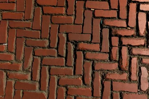 Rustic red clay brick walkway texture, old herringbone pattern street pavement Stock Photos