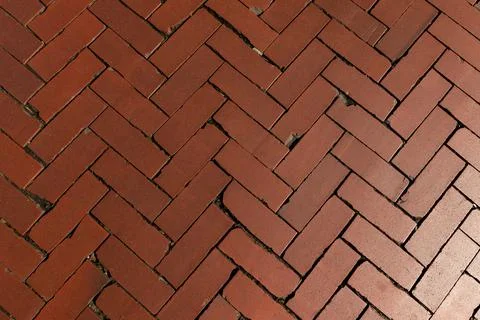 Rustic red clay brick walkway texture, old herringbone pattern street pavement Stock Photos