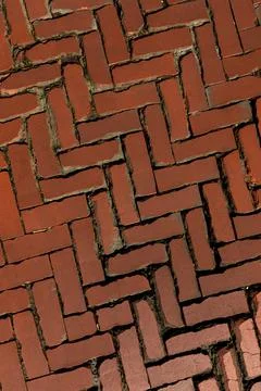Rustic red clay brick walkway texture, old herringbone pattern street pavement Stock Photos
