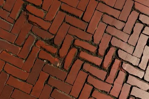 Rustic red clay brick walkway texture, old herringbone pattern street pavement Stock Photos
