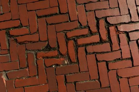 Rustic red clay brick walkway texture, old herringbone pattern street pavement Stock Photos