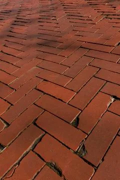 Rustic red clay brick walkway texture, old herringbone pattern street pavement Stock Photos